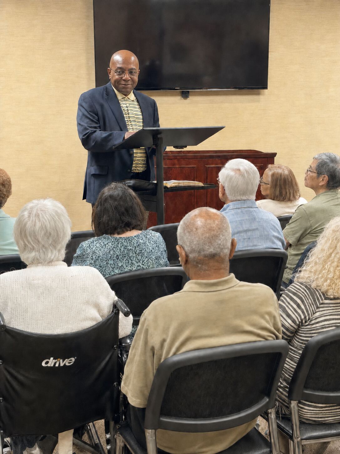 Elder Will Huff teaching Scripture at a senior residential care home