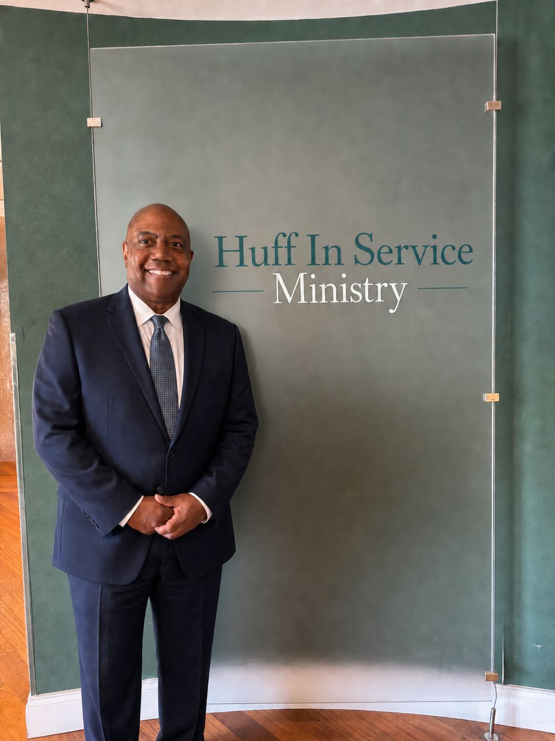 Elder Will Huff standing beside the Huff In Service Ministry office sign